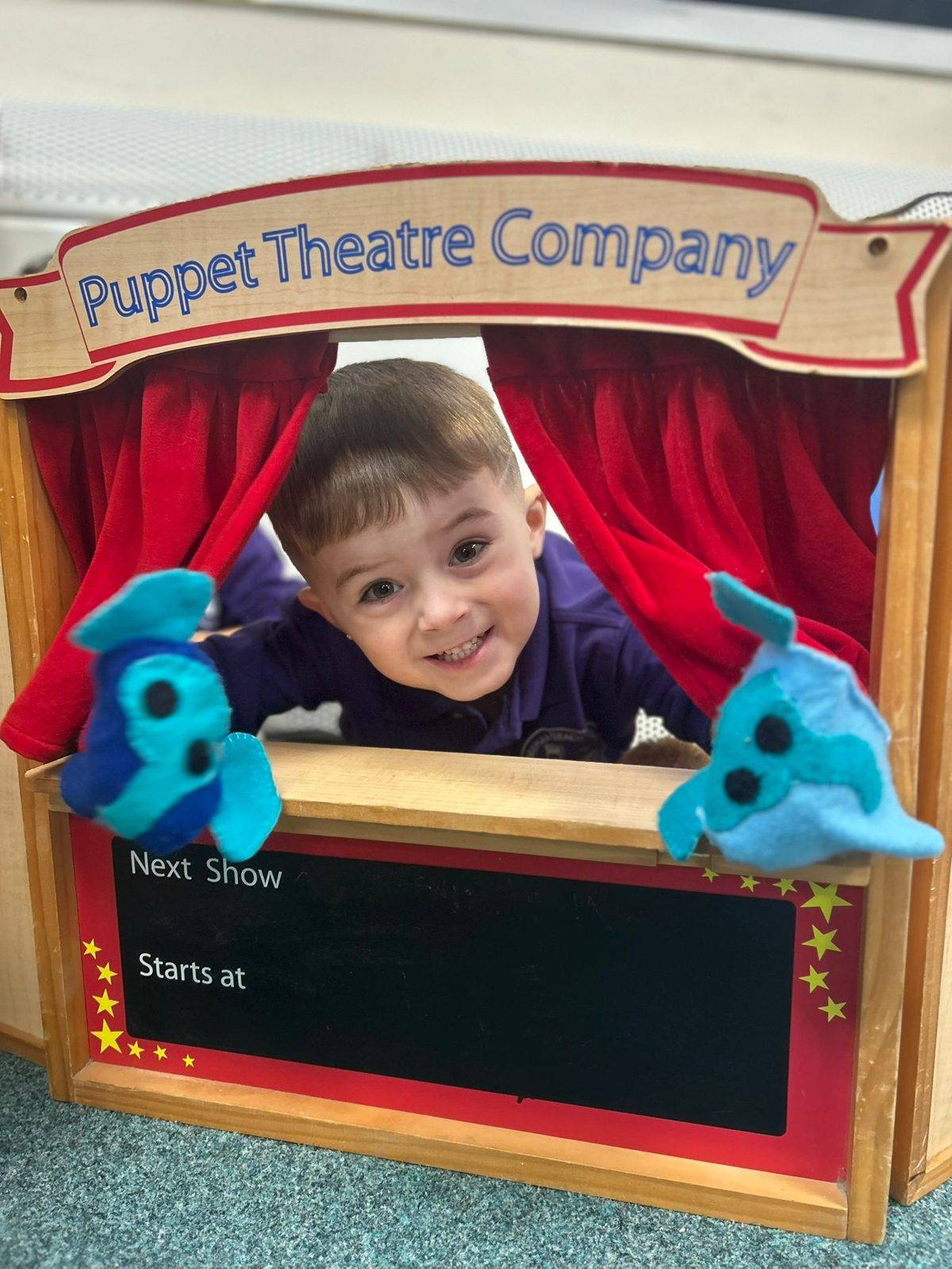 A child performing in the puppet theatre